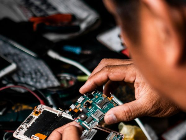 Technician at work on computer chips/board.