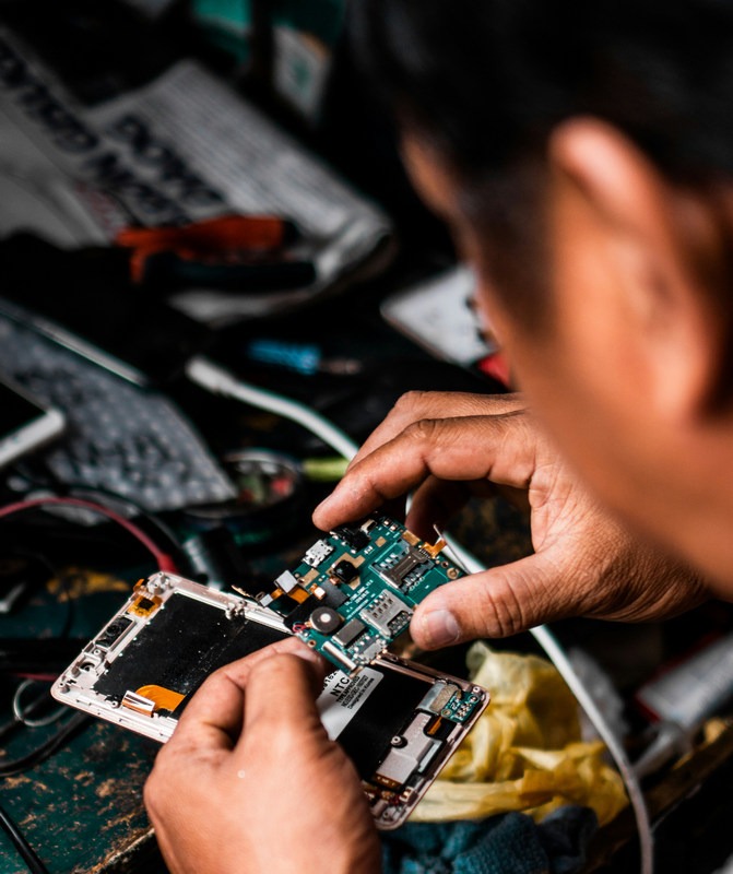 Technician at work on computer chips/board.